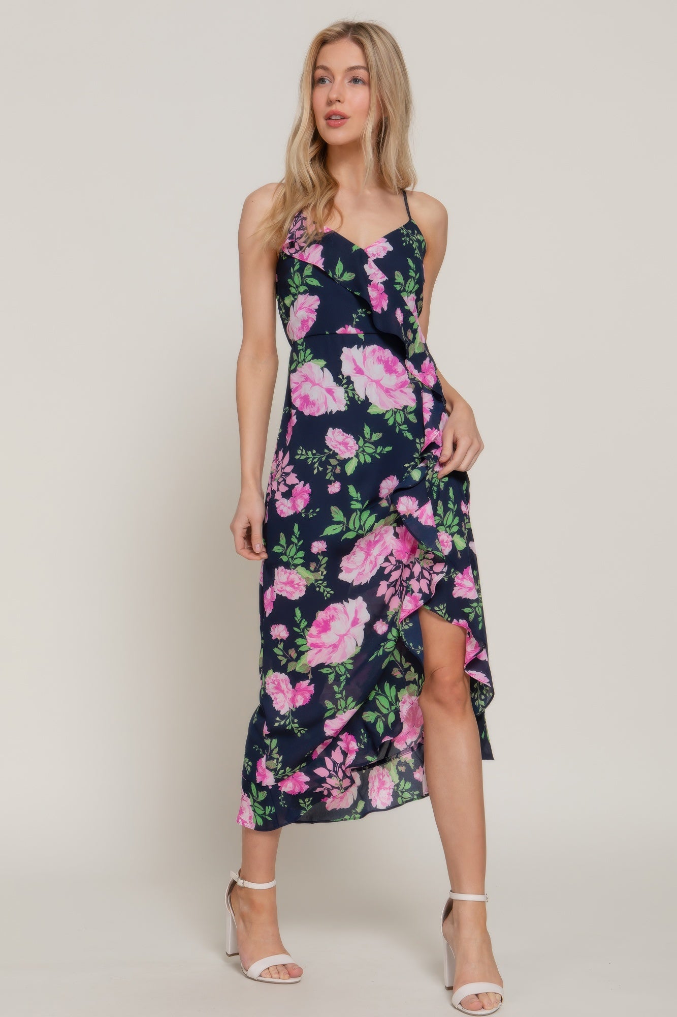 Model wearing navy floral ruffle midi dress with pink blossoms and high-low hemline-AVAH