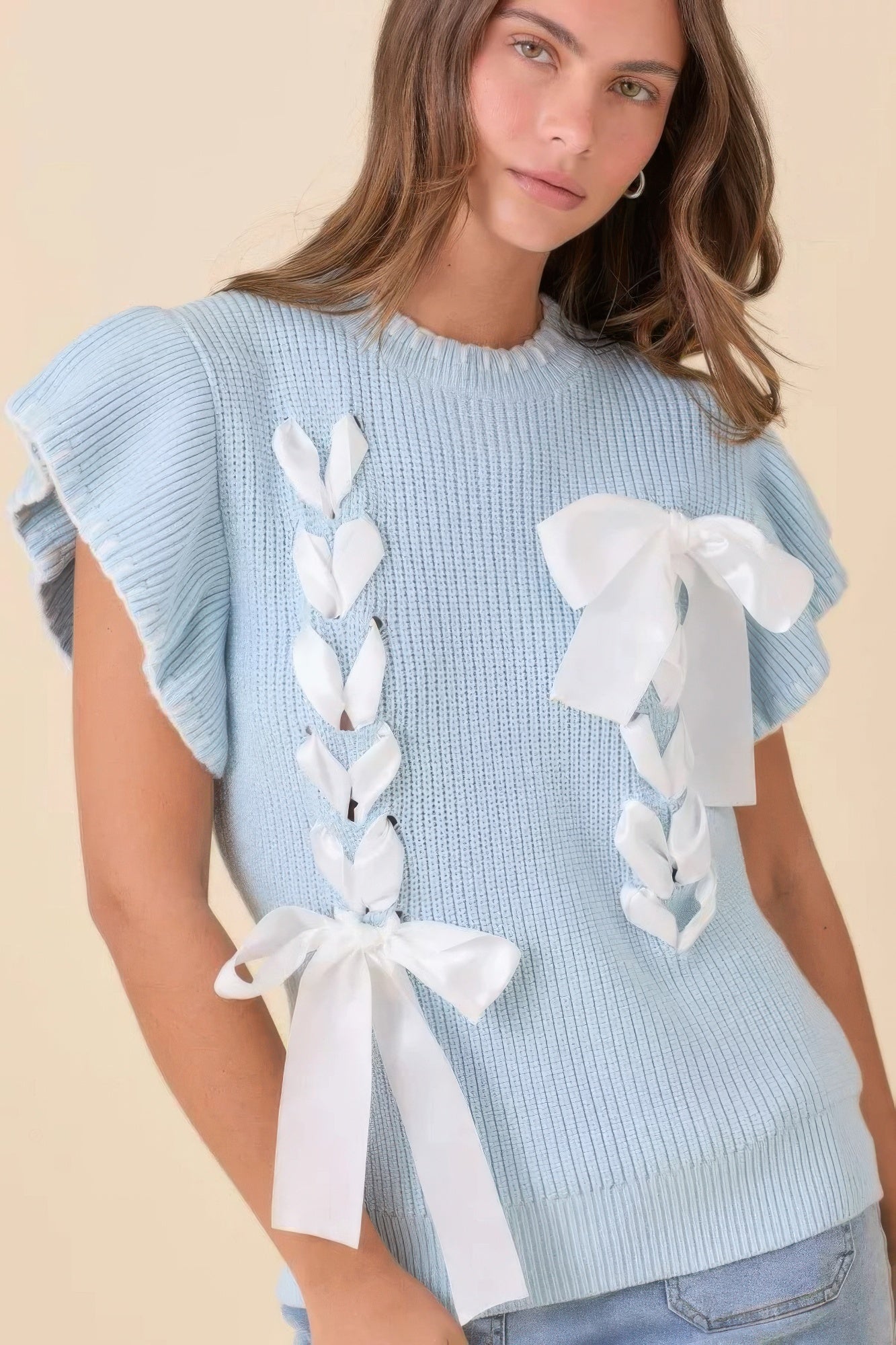 Front view of baby-blue ribbon-detail knit sweater with satin bows and flutter sleeves
