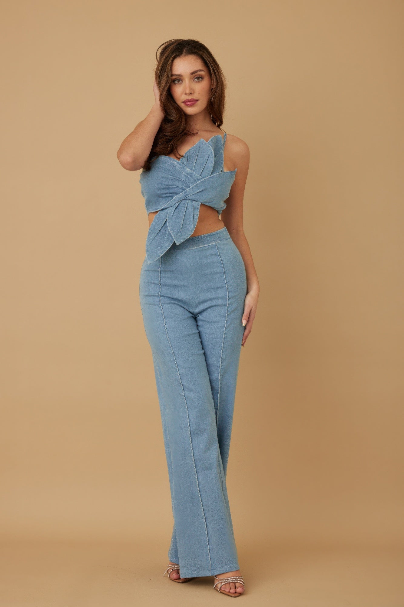 Blue two-piece set angled front view showing sculpted wrap top and fitted pants