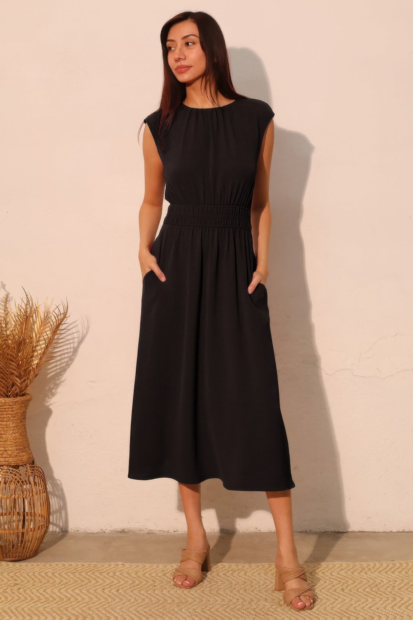 Black midi dress with smocked waist and cap sleeves