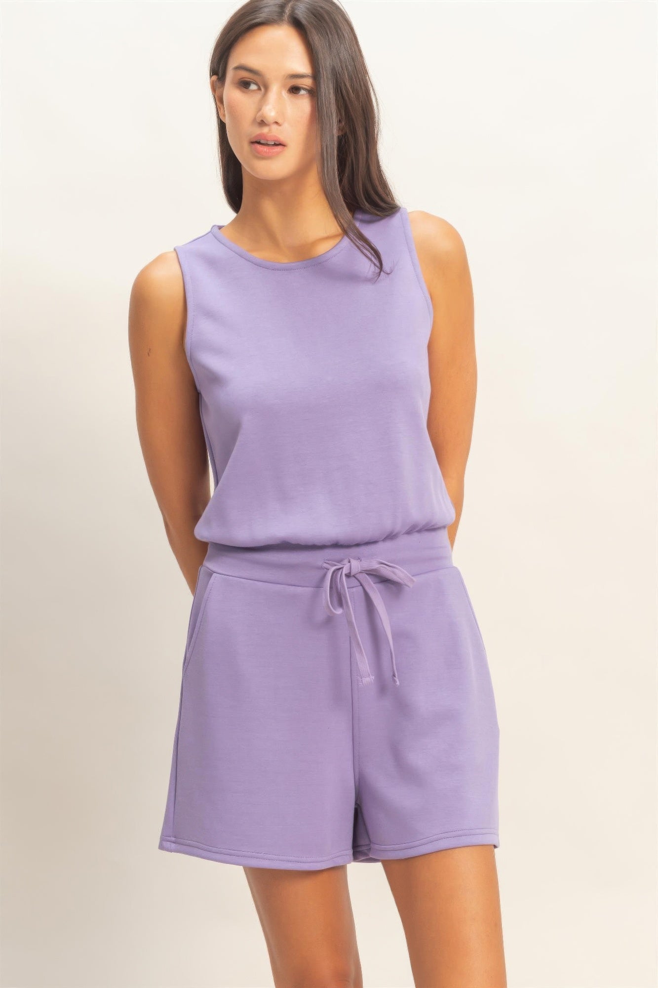 Front view of lavender knit romper with pockets and soft stretch fabric