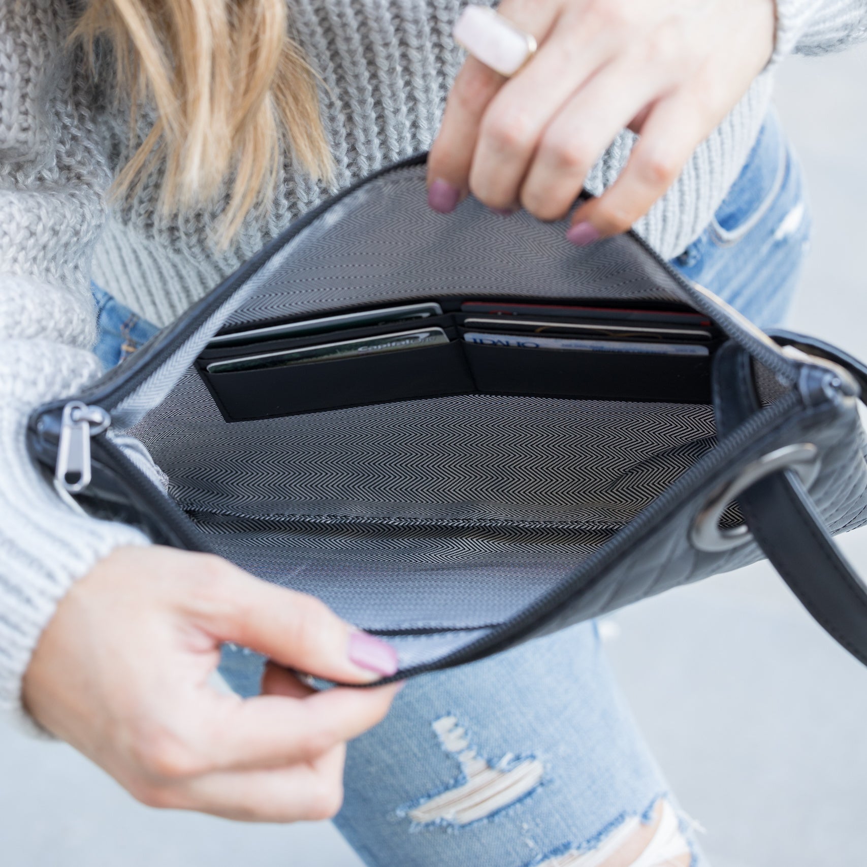 Navy quilted clutch made with a premium soft quilted PU leather and cotton Herringbone print lining with grommet detail and wristlet inside view