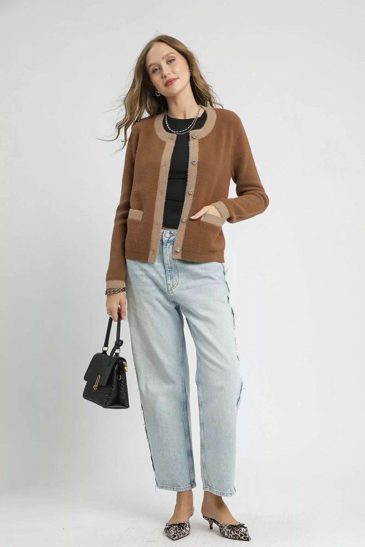 Model styling latte brown Camille Contrast Trim Knit Cardigan with light wash jeans, black top and leopard print heels.