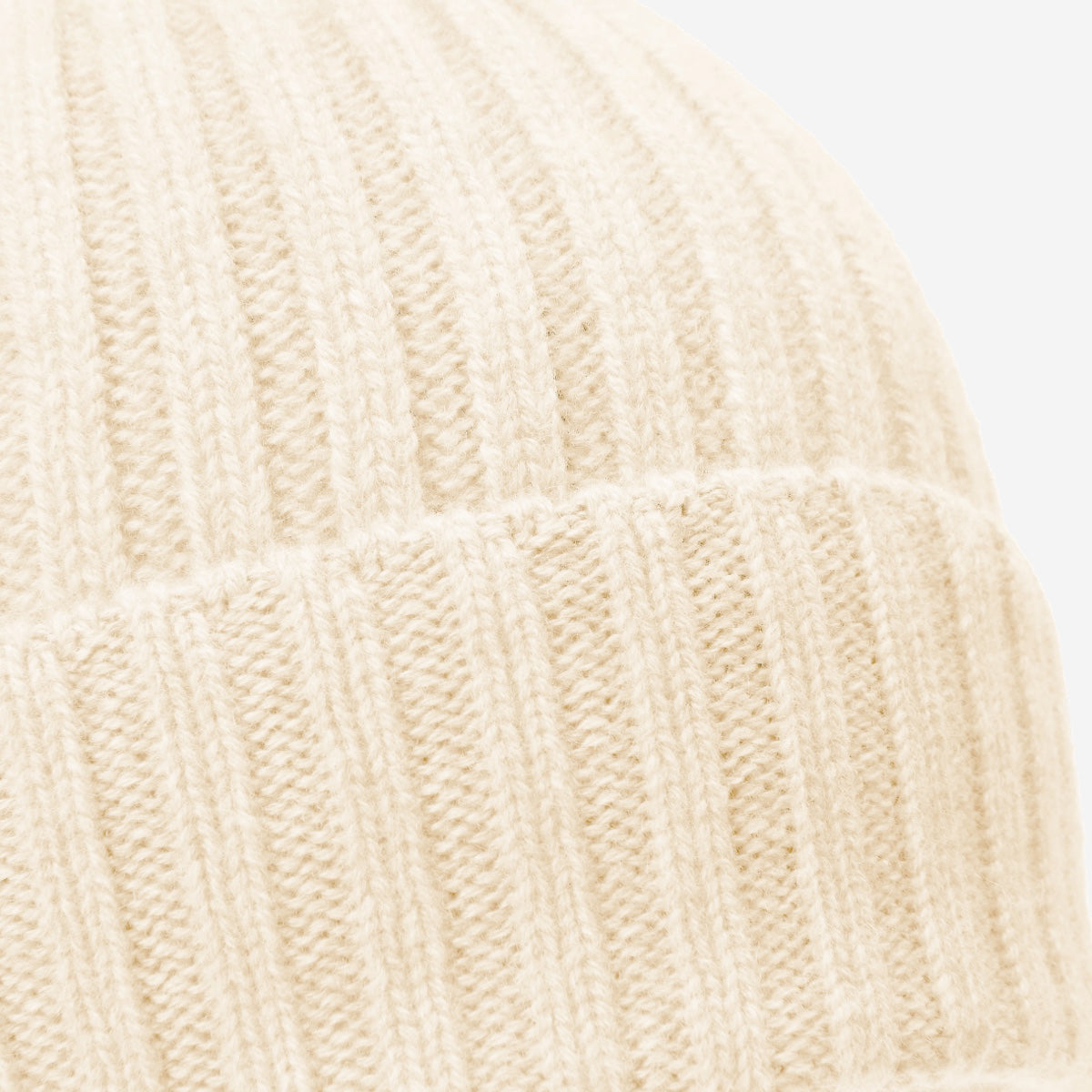 Close-up of an ivory cashmere knitted fabric texture