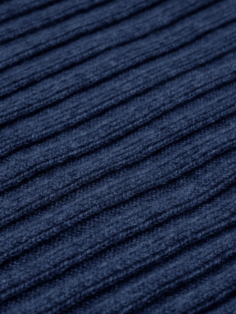 Close-up of blue textured cashmere fabric with horizontal lines