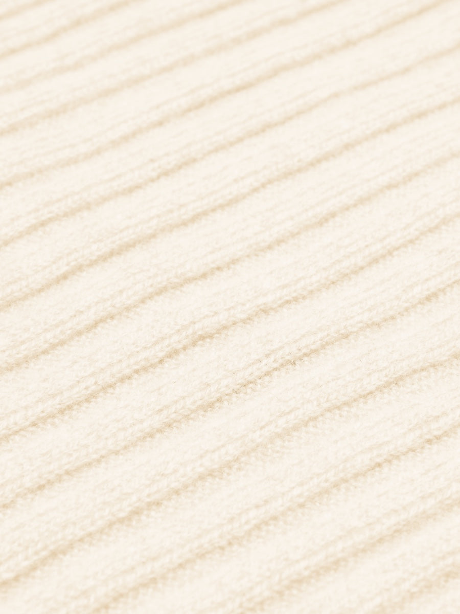 Close-up of cream cashmere fabric texture with horizontal lines