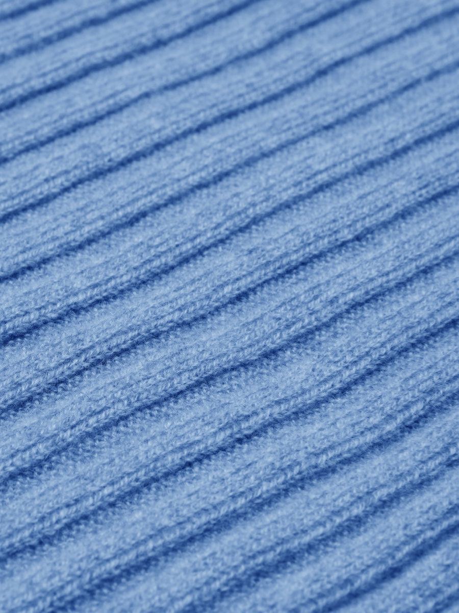 Close-up of blue textured cashmere fabric with horizontal lines