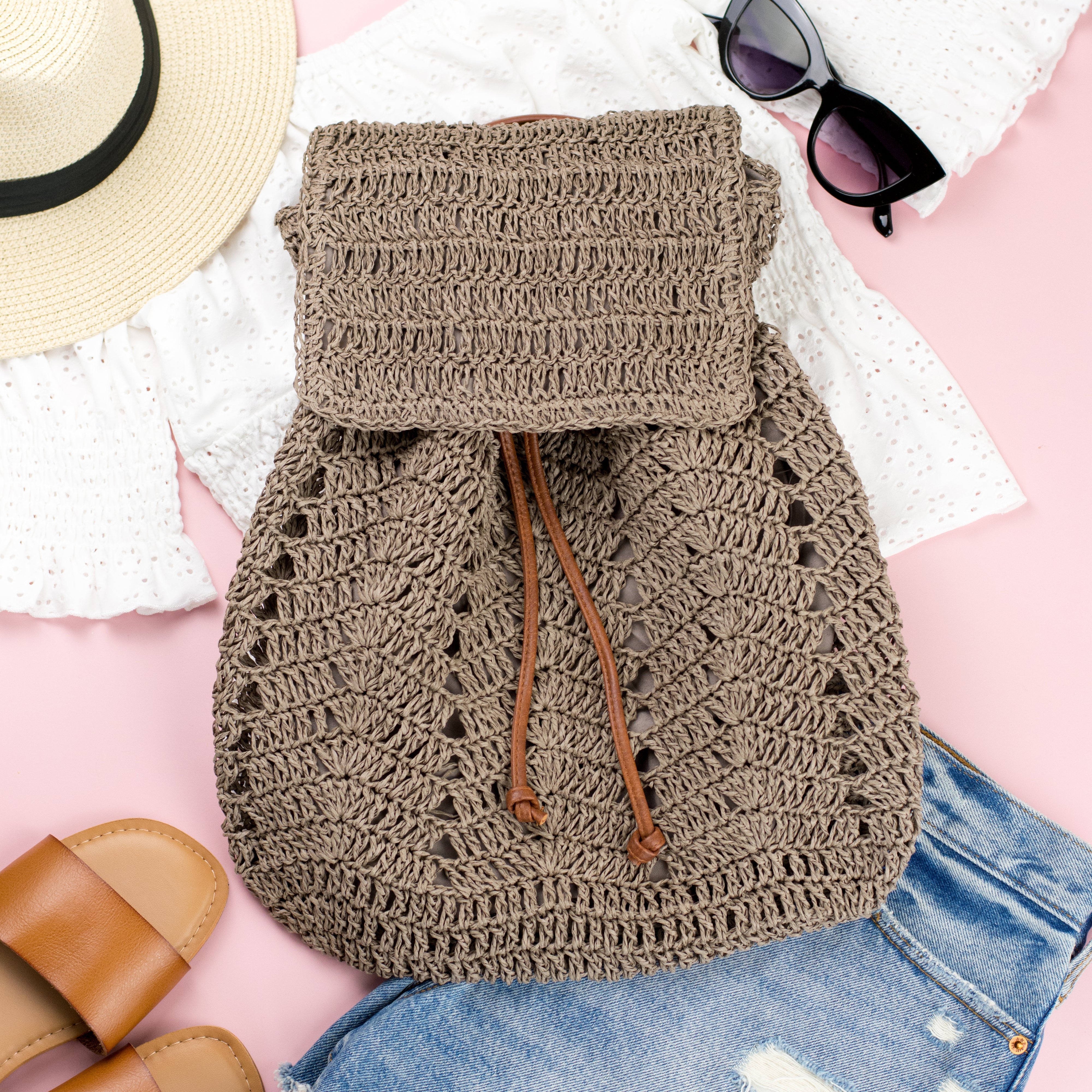 AVAH-closeup of dark khaki woven crochet backpack with brown leather straps