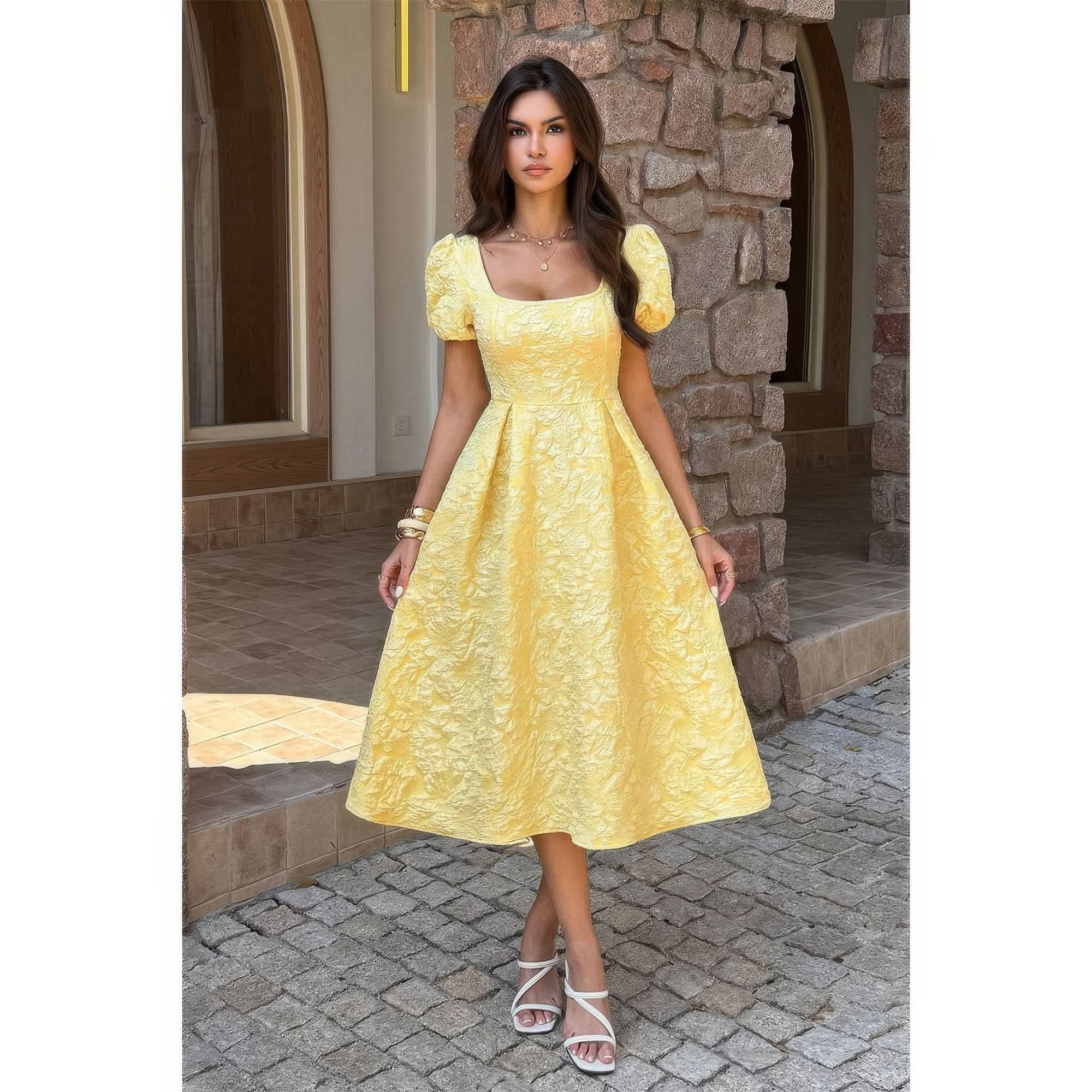 Model wearing yellow jacquard puff sleeve midi dress with square neckline and full skirt.