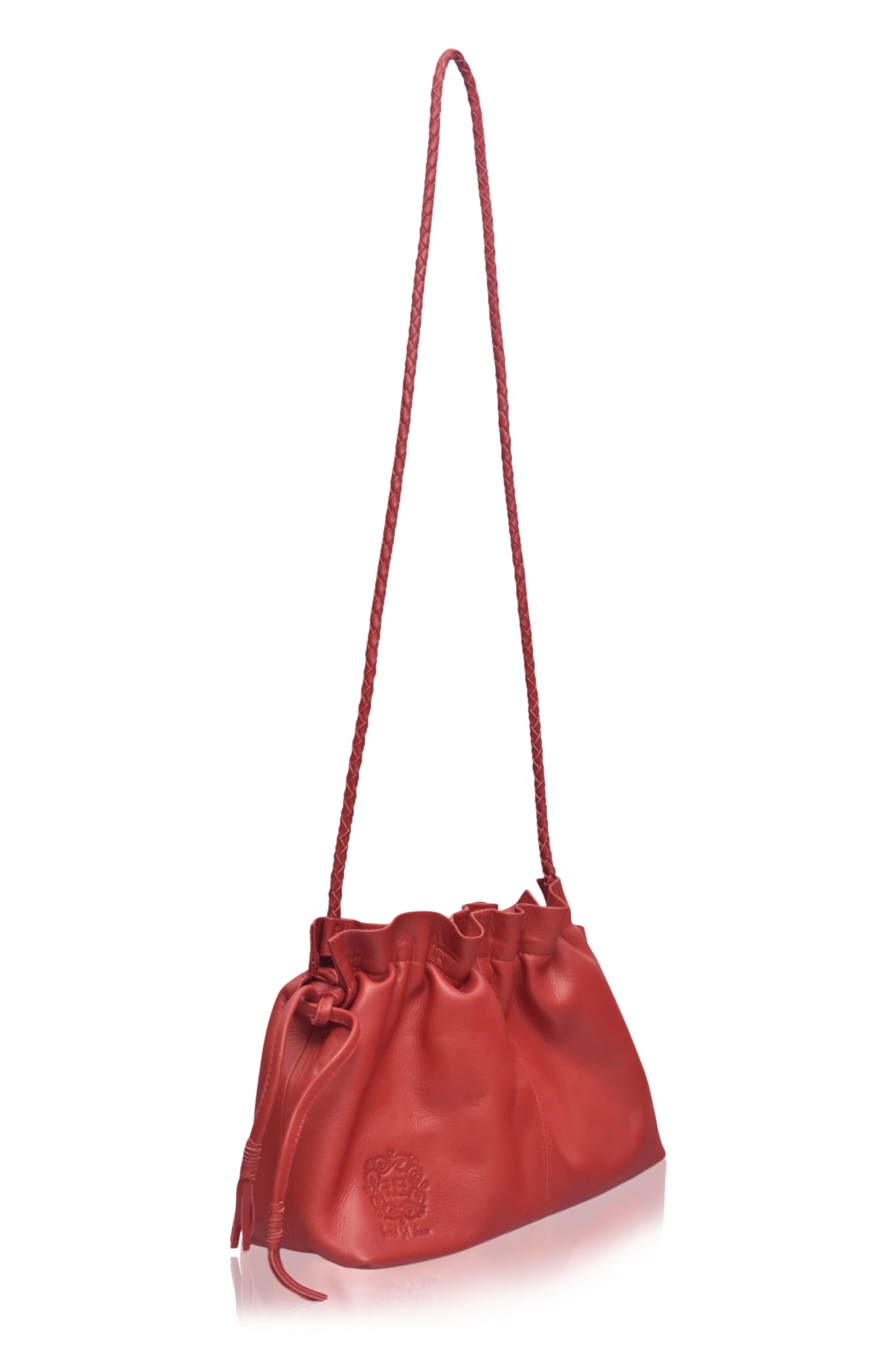 Red leather handbag with a drawstring on a white background