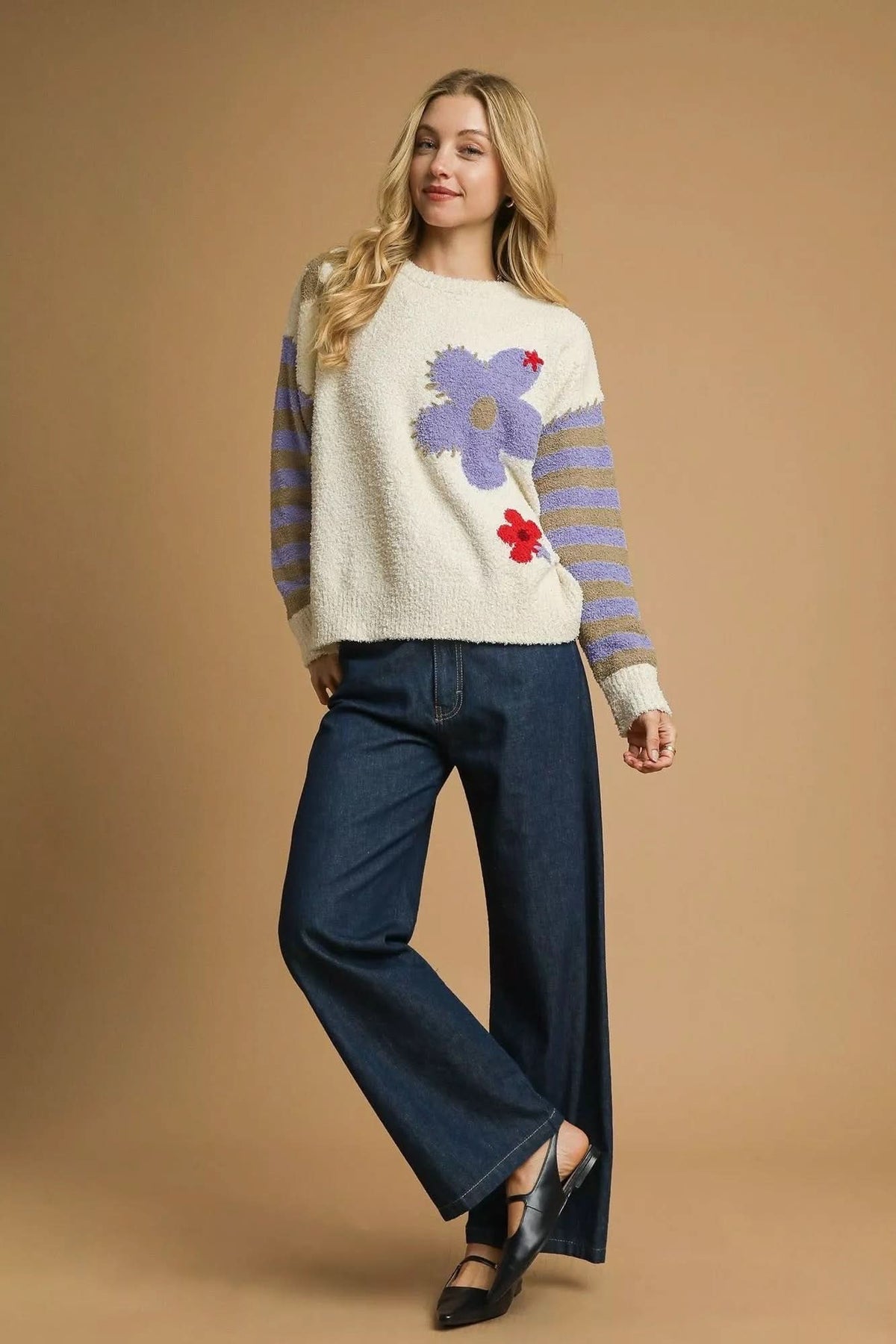 Model wearing Flower Child Cozy Knit Sweater with dark wash wide leg jeans and black flats.