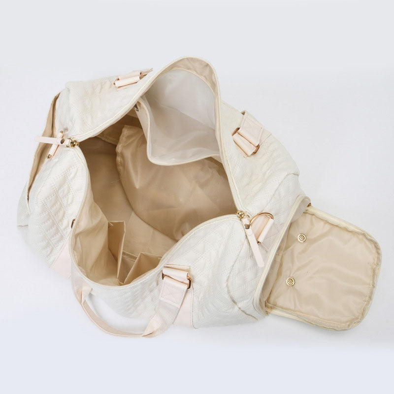 AVAH-Weekend Bliss Quilted Travel Bag in Bisque featuring a timeless design with vegan leather accents, Exterior open side pocket, luggage/trolley sleeve, shoe compartment, zip pocket and gold hardware