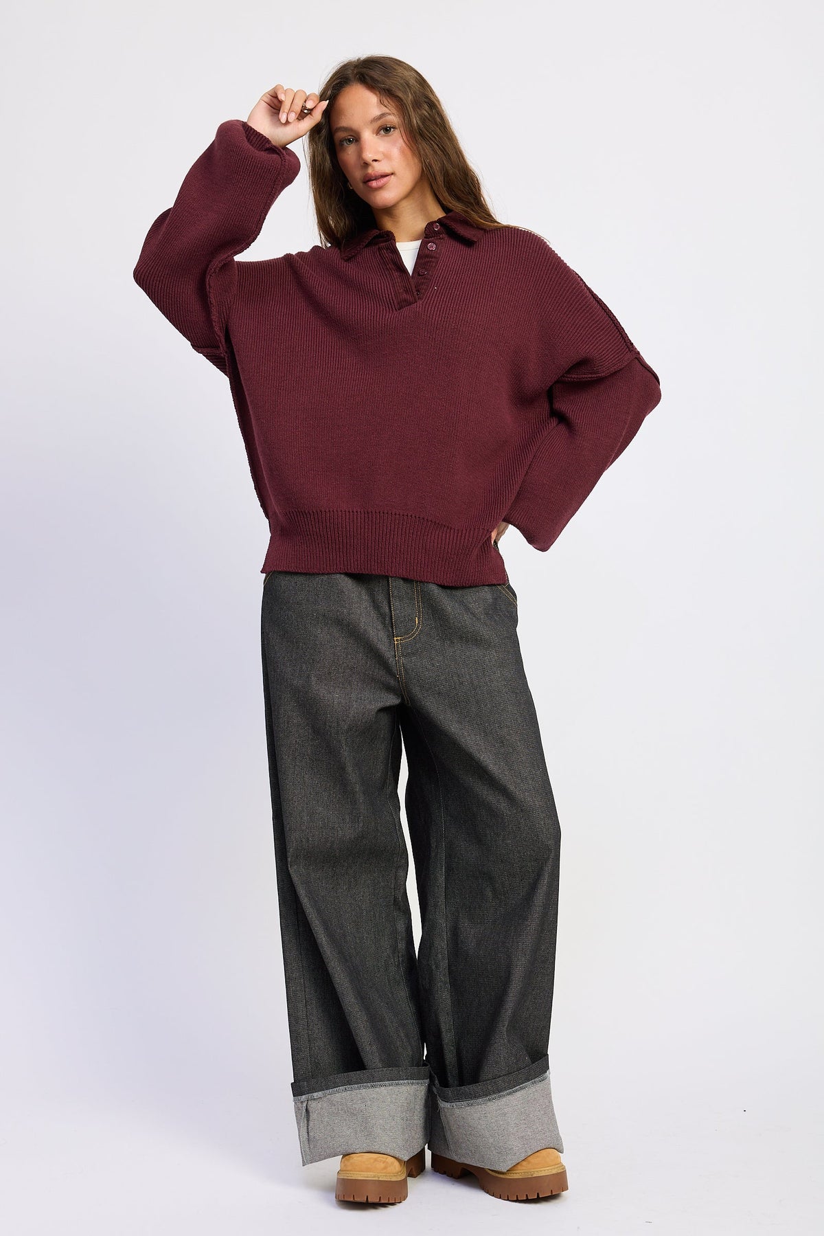Full length model view wearing burgundy Weekend Club Collared Knit Sweater with dark wide leg denim.