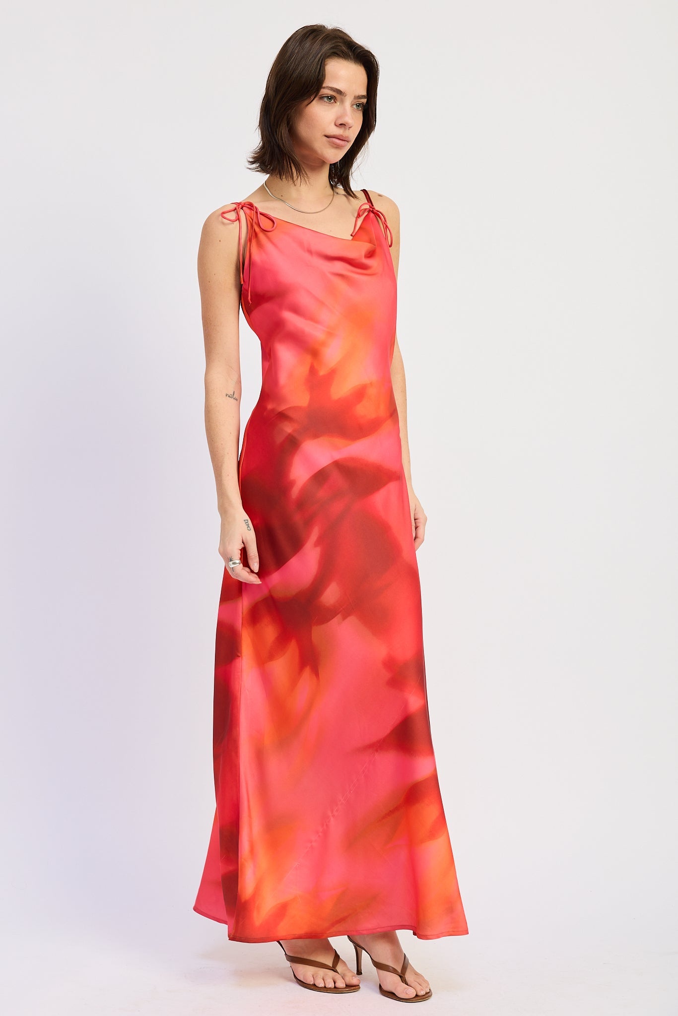 Side view of coral and red floral maxi dress with cowl neckline and shoulder ties