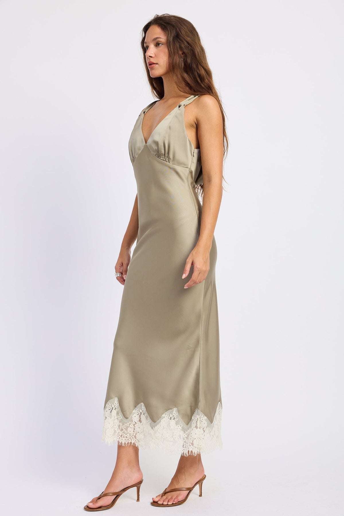 Woman wearing bias-cut satin midi dress with lace hem in Light Olive.