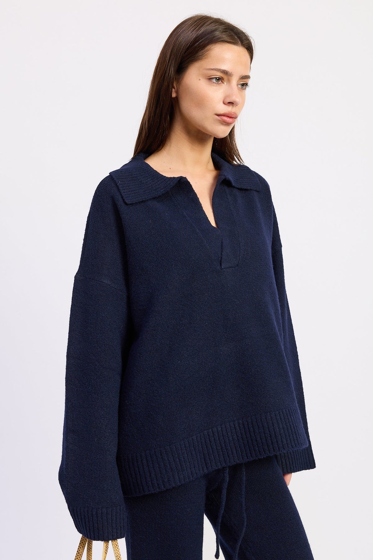 Side view of Harbor Lounge navy knit sweater showing dropped shoulders, roomy sleeves and ribbed hem.