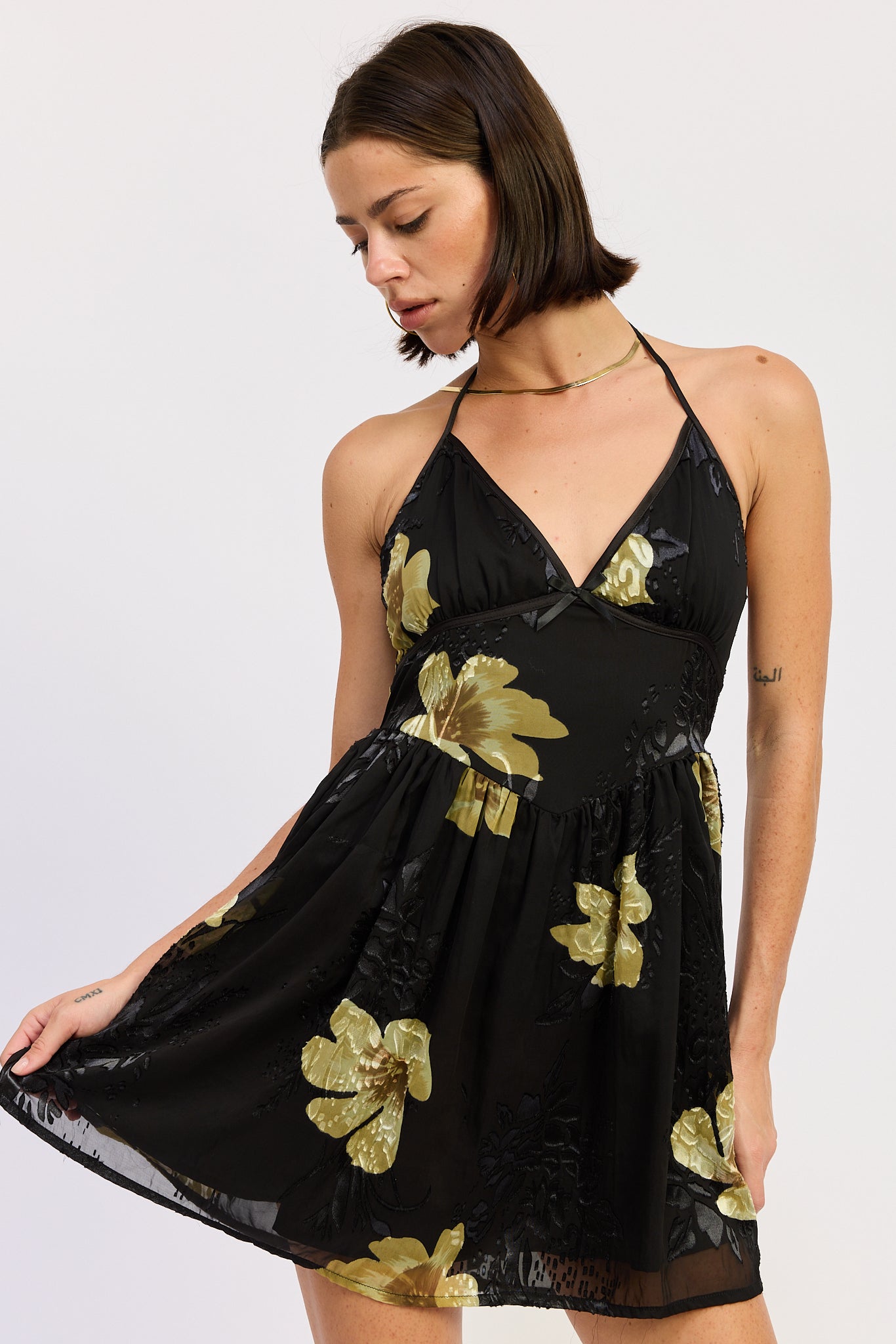 Black halter mini dress with gold floral print, front full-body view-AVAH