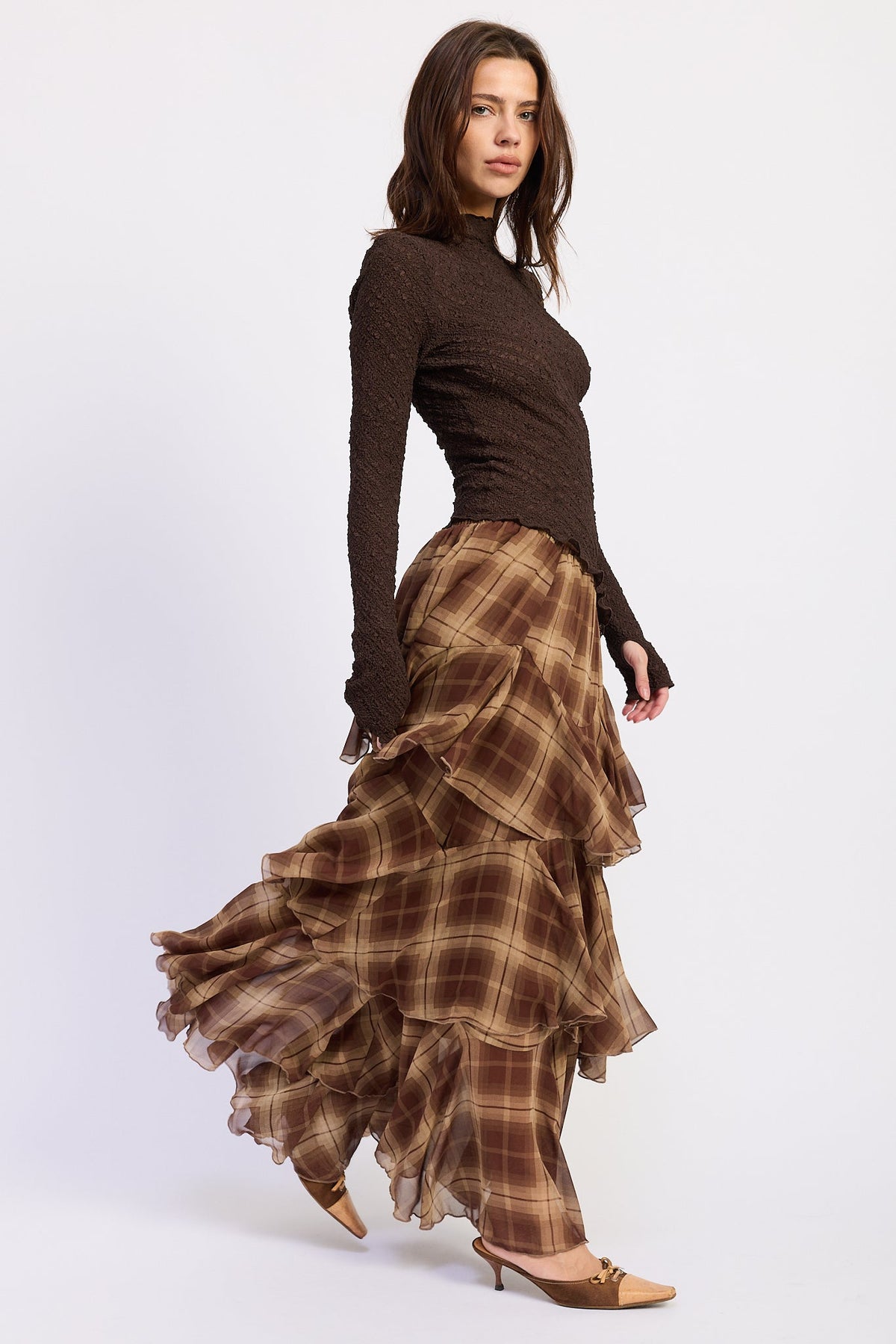 Side view of Maplewood Plaid Ruffle Maxi Skirt showing brown plaid pattern and layered ruffles.