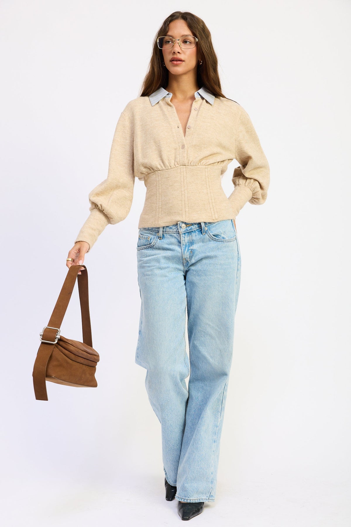 Full length model wearing oatmeal Cambridge Contrast Collar Sweater with striped collar, fitted waist and light wash jeans.