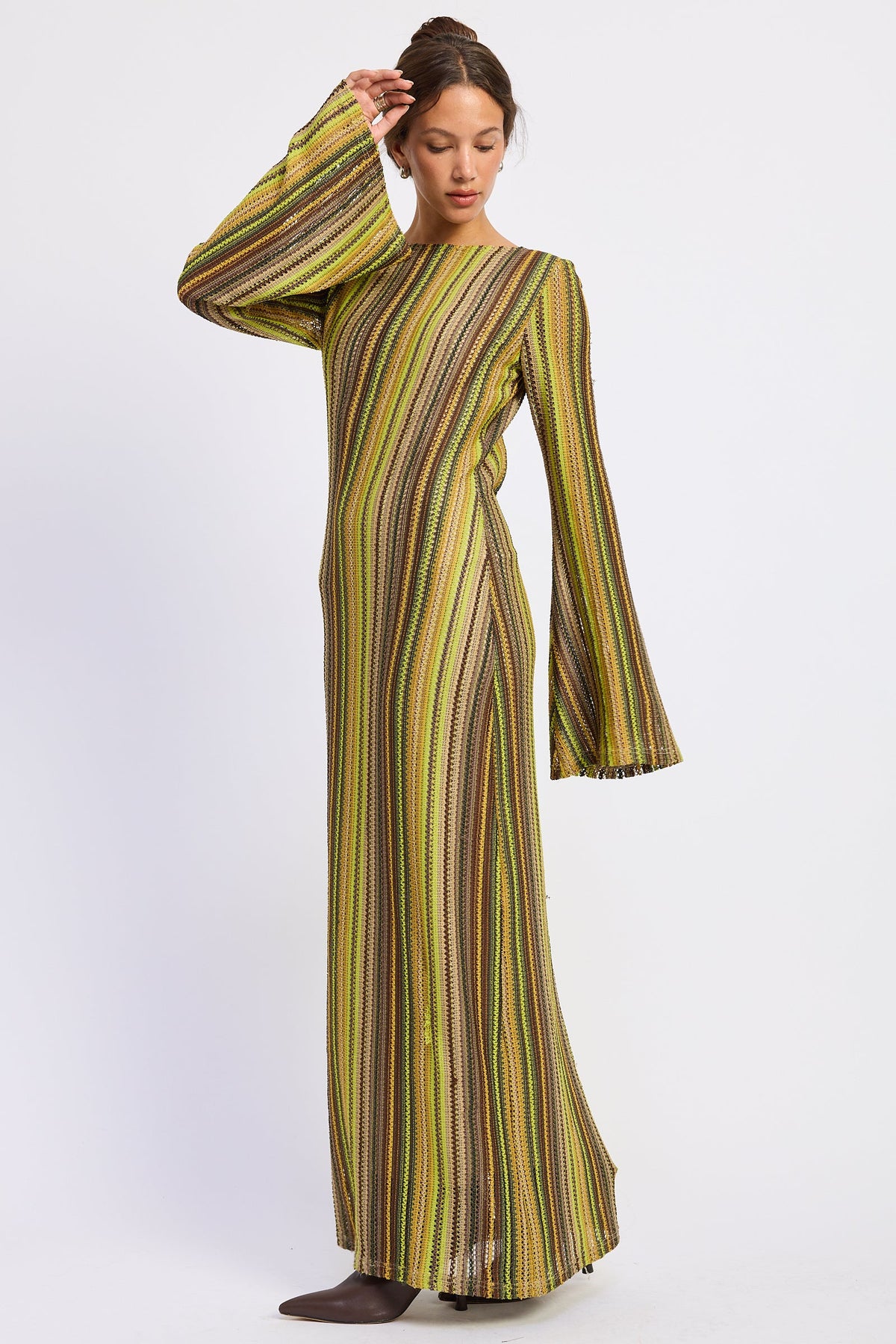 Angled view of Solstice Stripe Long Sleeve Maxi Dress showing textured stripes in olive, mustard, and brown with long flared sleeves.