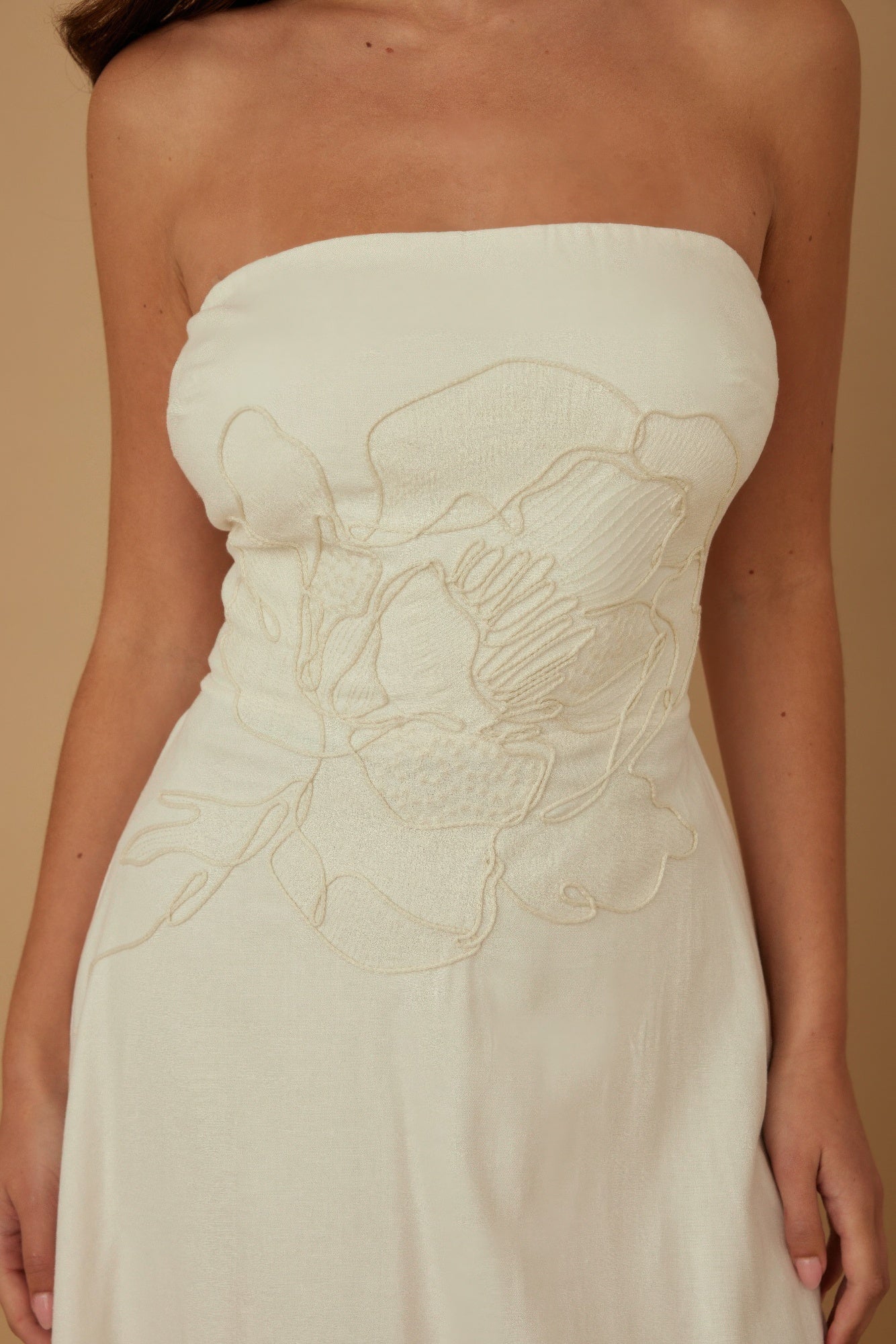 Close-up of floral embroidery detailing at the front bodice