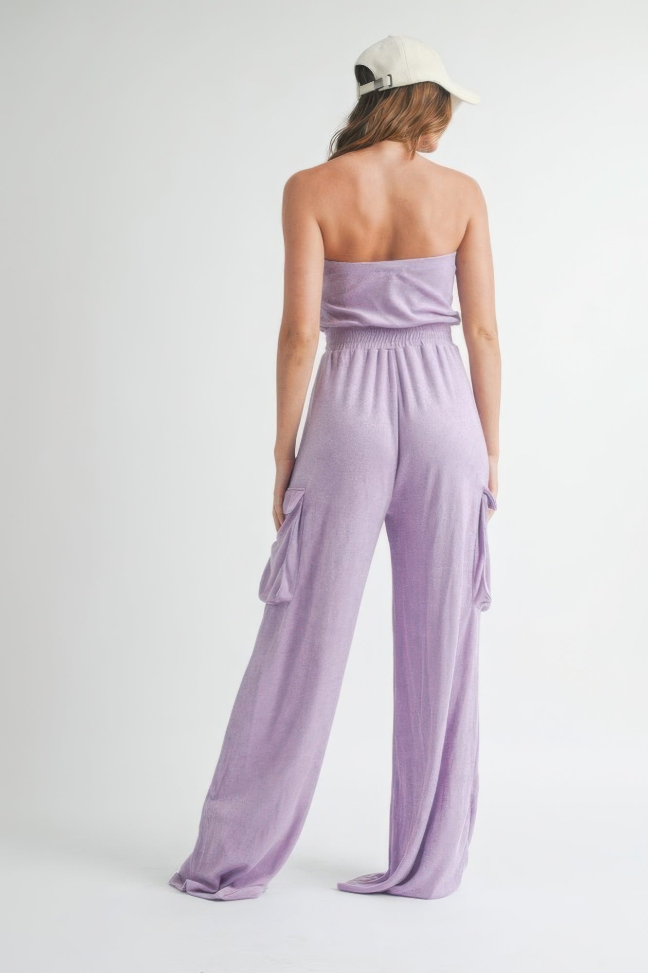 Back view of lavender strapless jumpsuit showcasing breezy wide legs.