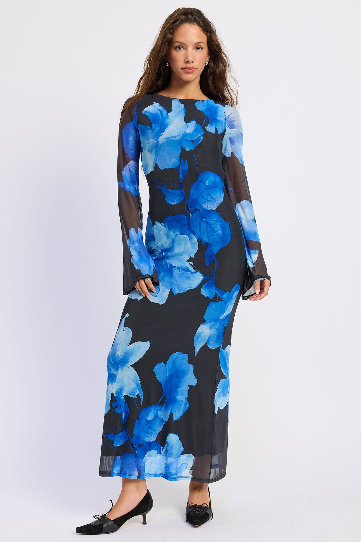 Full front view of Blue Reverie Floral Long Sleeve Maxi Dress featuring vivid blue flowers, boat neckline and long sheer sleeves.