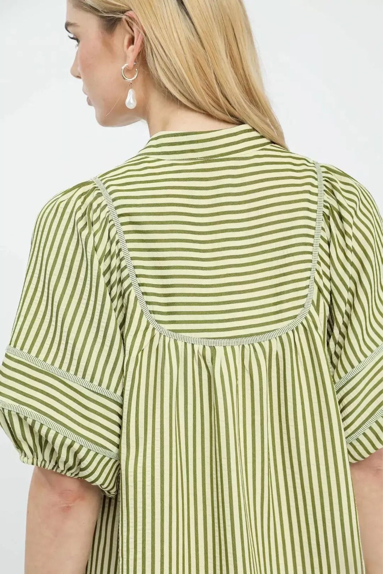 Close back detail of green stripe dress showing contrast topstitching and gathered yoke, AVAH
