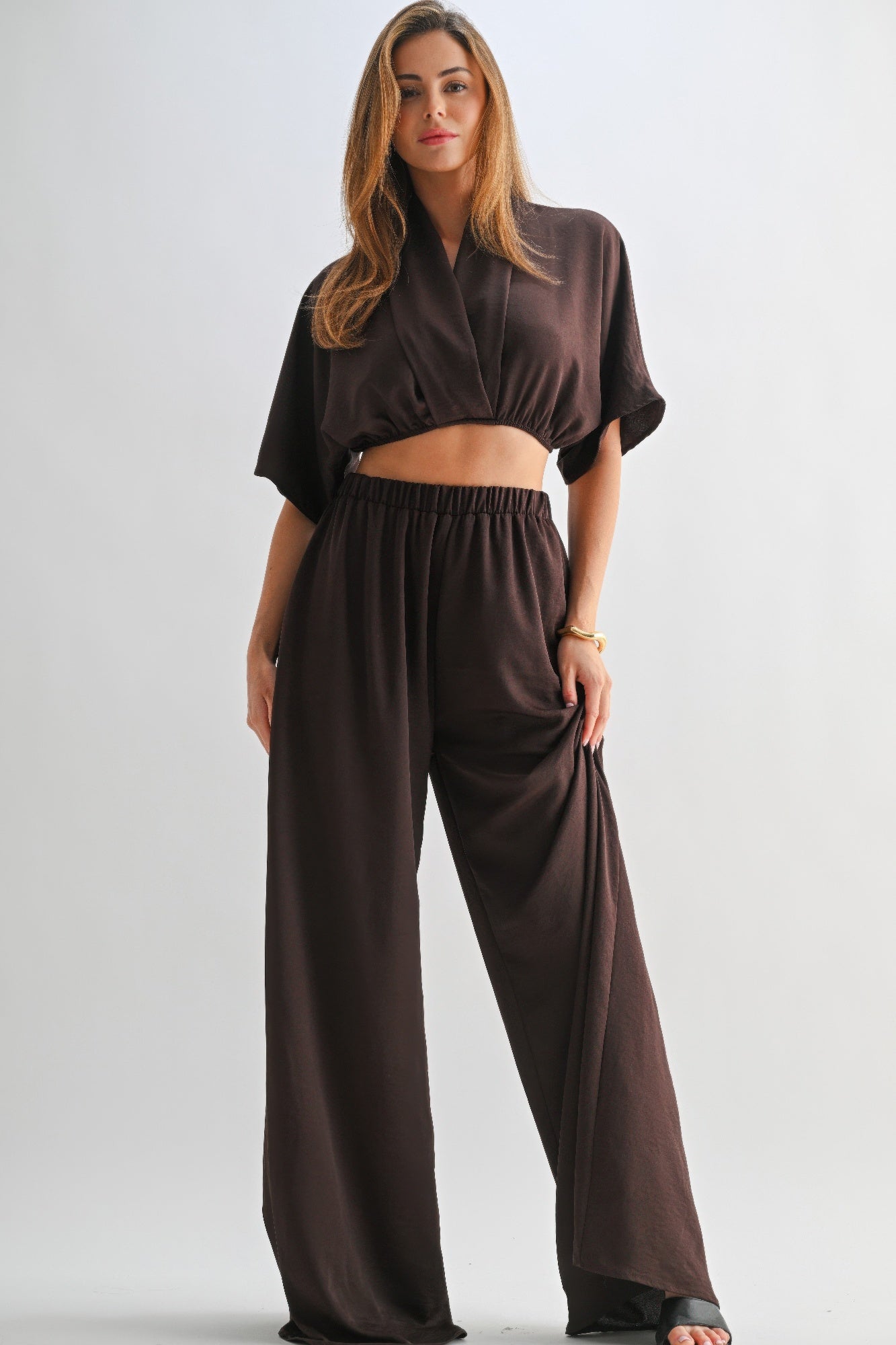 Model wearing chocolate brown two-piece lounge set, featuring shawl collar top and wide-leg pants-AVAH