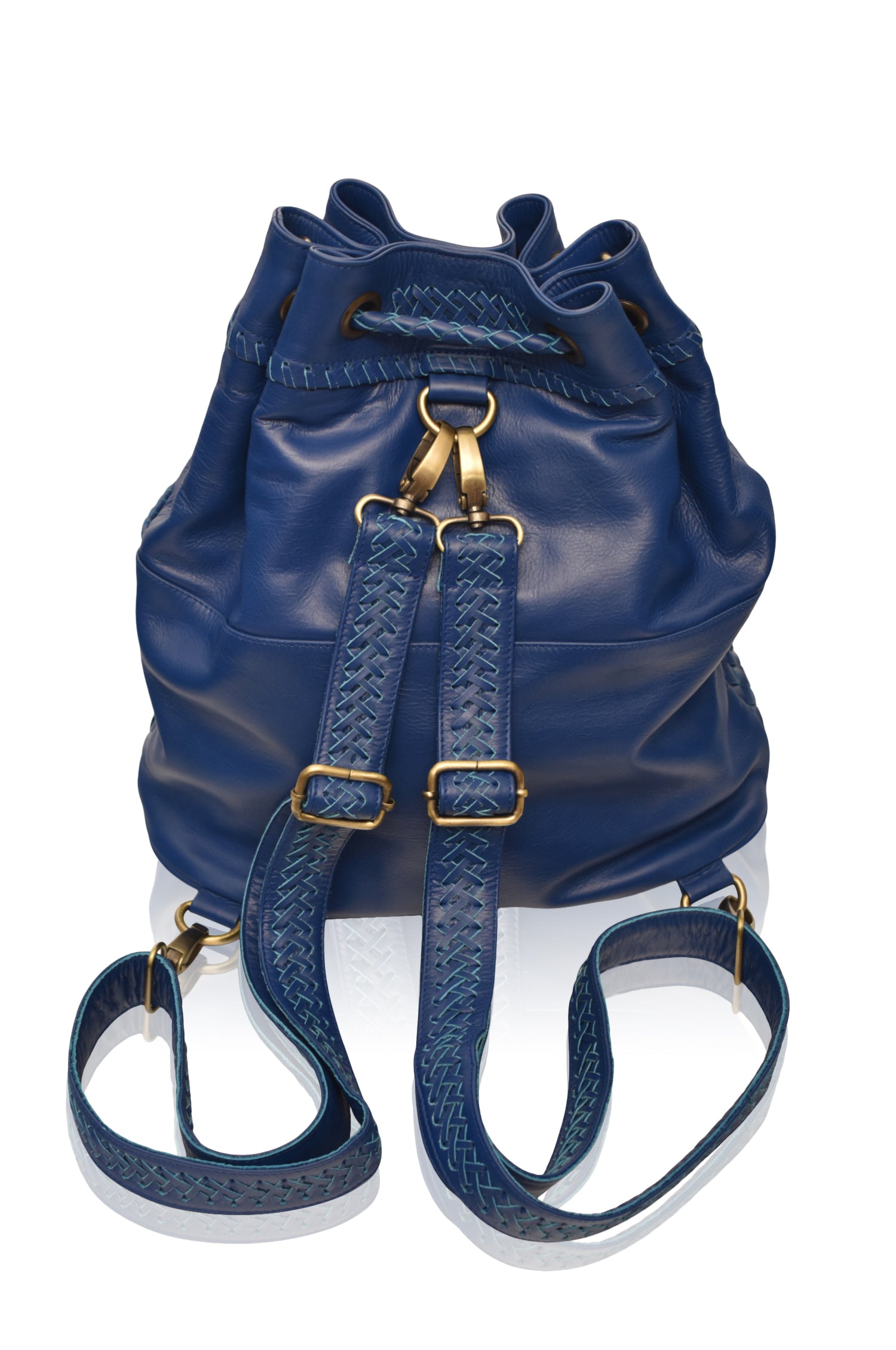 Blue leather woven backpack/handbag with braded drawstring opening and braided adjustable straps with brass hardware on the front on white background, back view