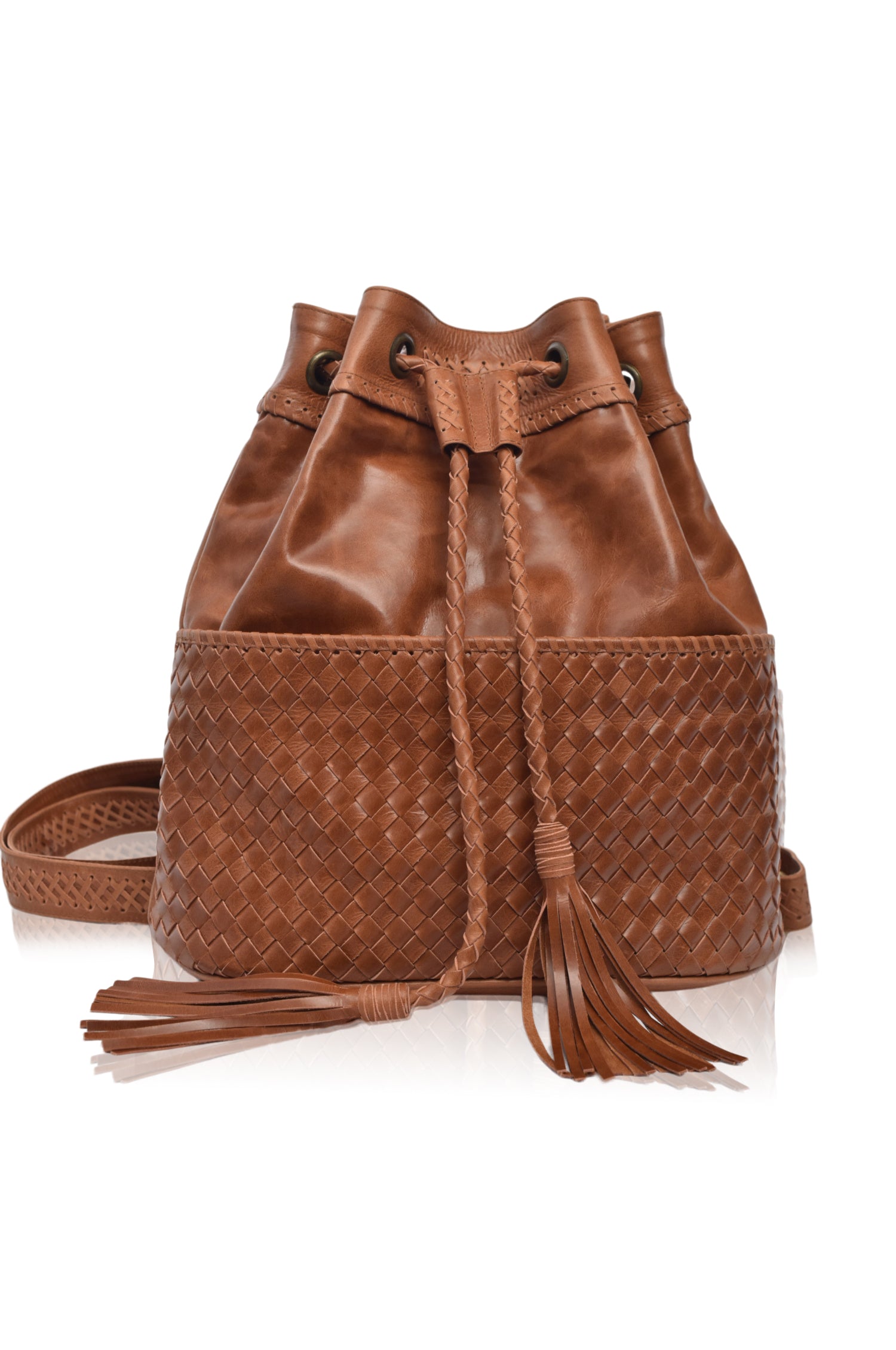 Camel leather woven backpack/handbag with braded drawstring opening and woven detail pocket on the front on white background, front view