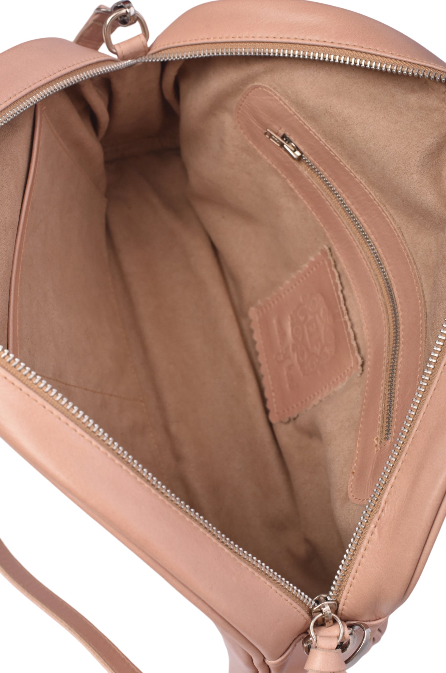 Close-up of a beige suede lined beige leather bag with visible stitching, interior pockets and brand logo.