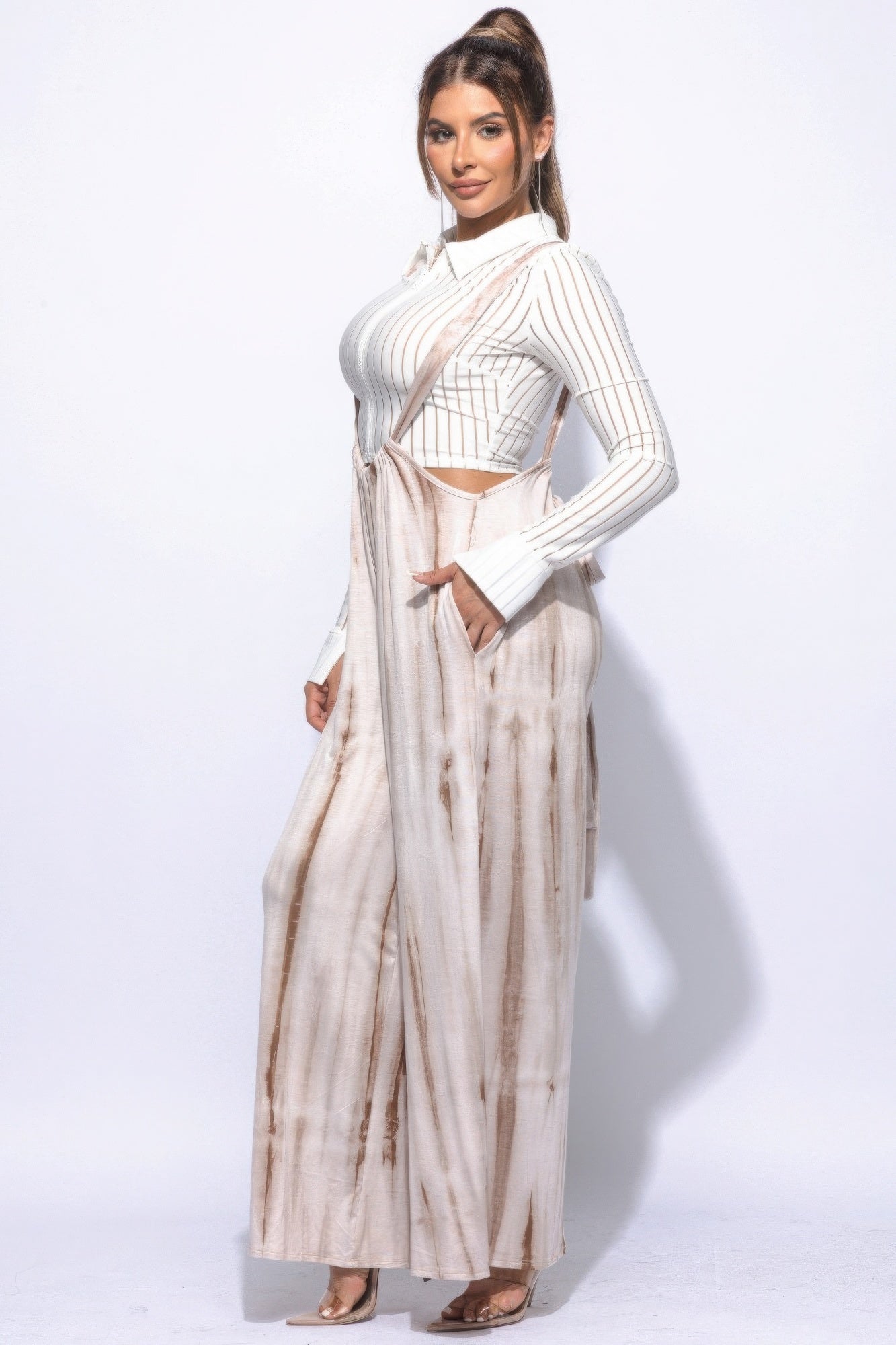 Side profile of woman in Sahara Glow jumpsuit highlighting pocket and natural-tone tie-dye fabric.
