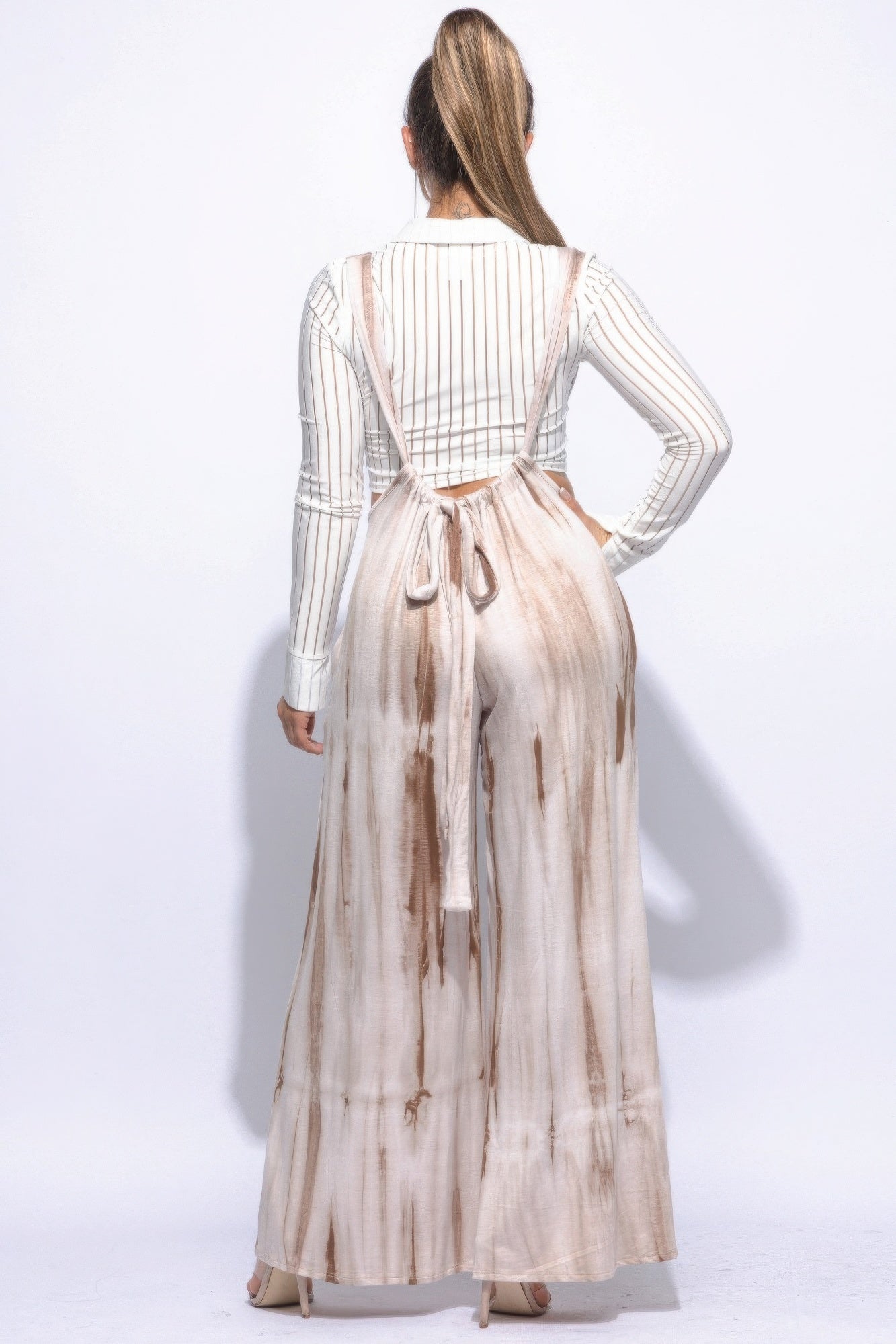 Back view of Sahara Glow jumpsuit showing tie detail and flowy legs.