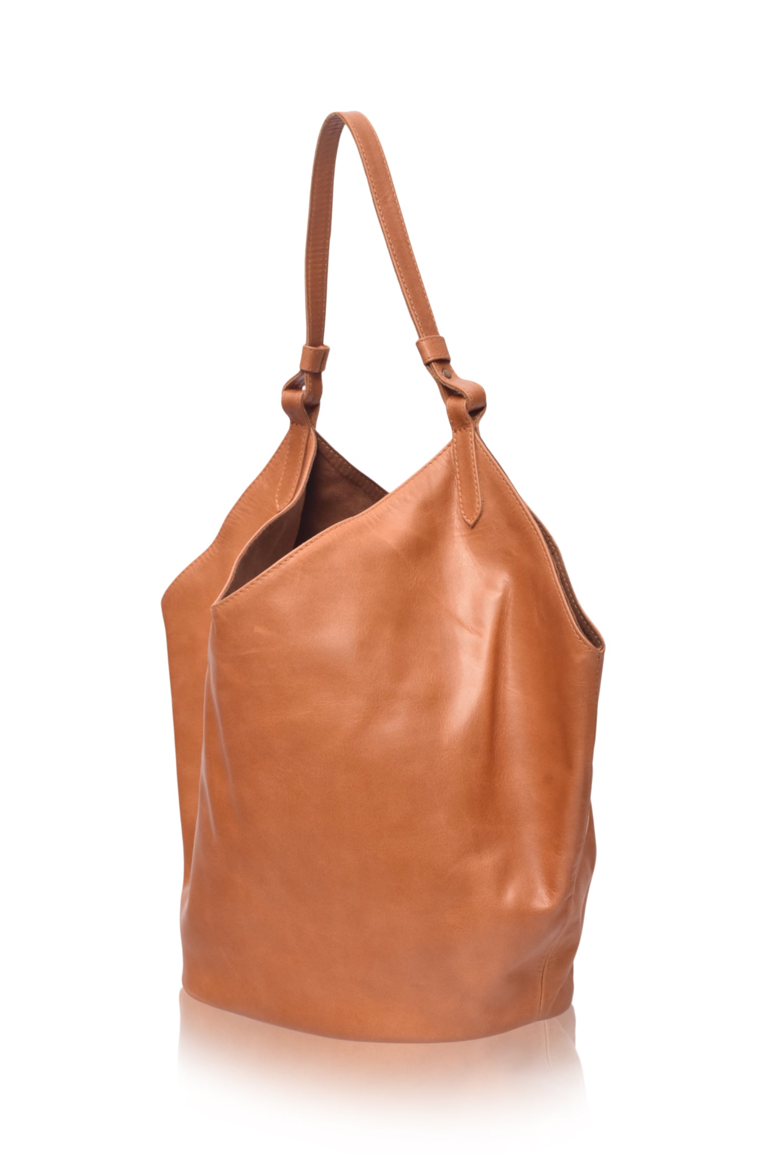 Tan leather handbag on a white background, side view