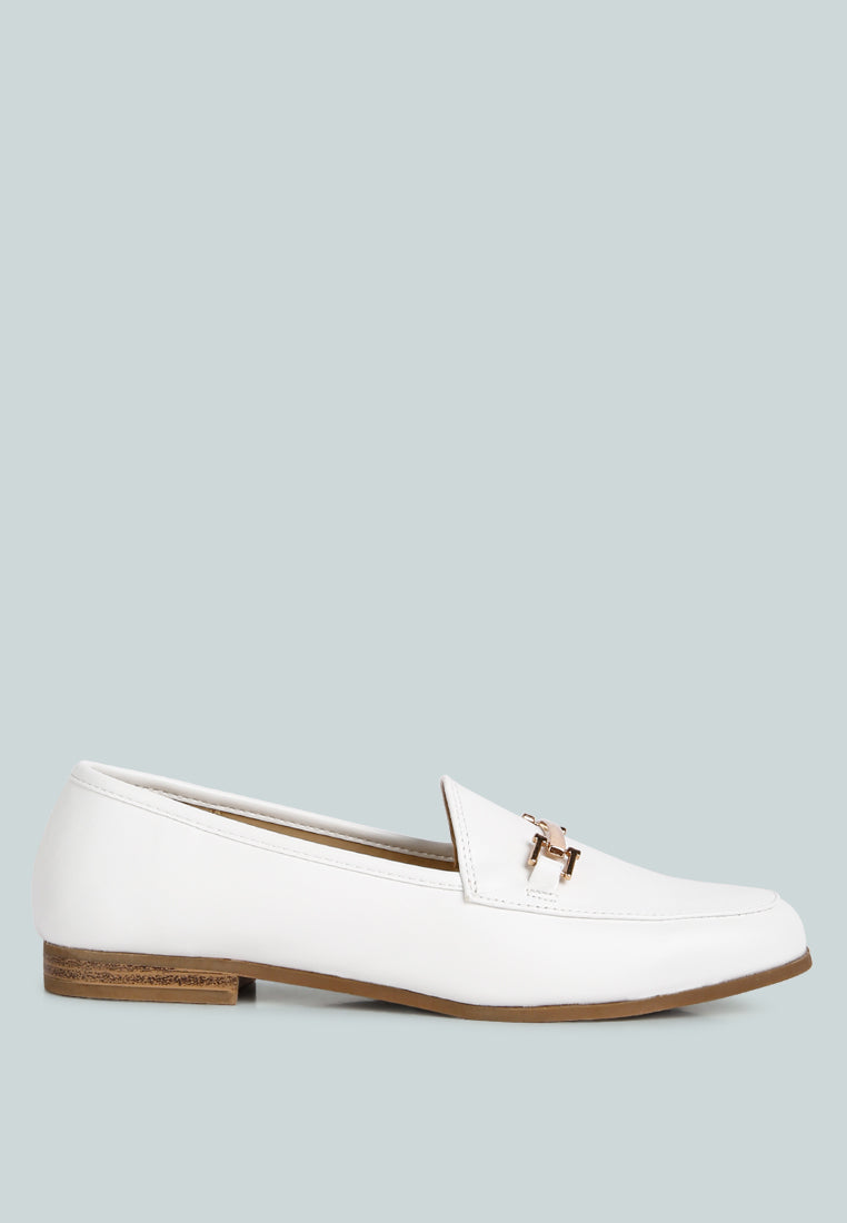 White loafer shoe with a gold buckle on a light gray background
