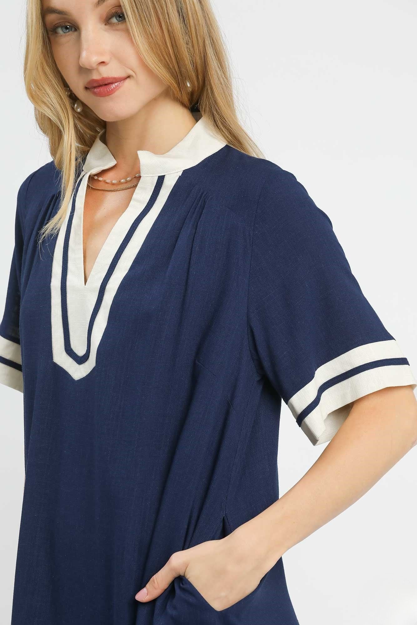 Close detail of Yacht Club Linen Mini Dress showing contrast neckline and striped sleeve cuff, AVAH