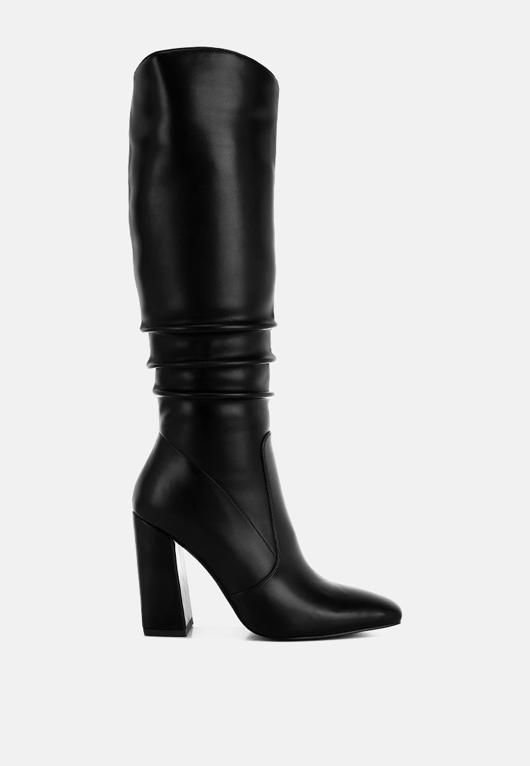 Vienna Sculpted Heel Knee High Boots in black faux leather featuring subtle slouch detailing, square toe and 4 inch block heel.