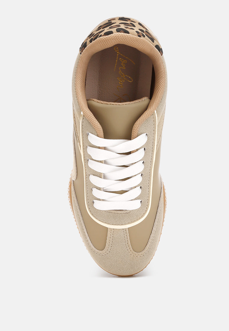 Beige sneaker with leopard print and metallic accents on a white background, top view