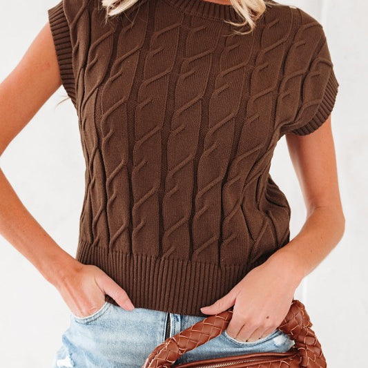 Front view of brown cable knit sleeveless top styled with light denim shorts and woven bag.