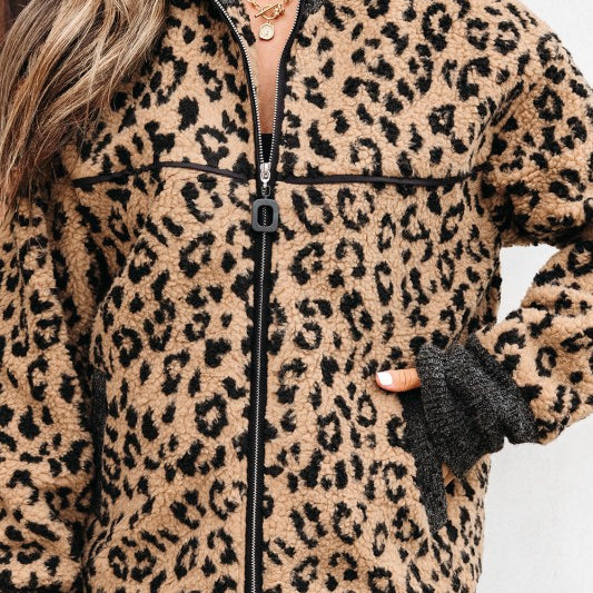 close-up of woman wearing leopard sherpa jacket zipped up with contrast cuffs