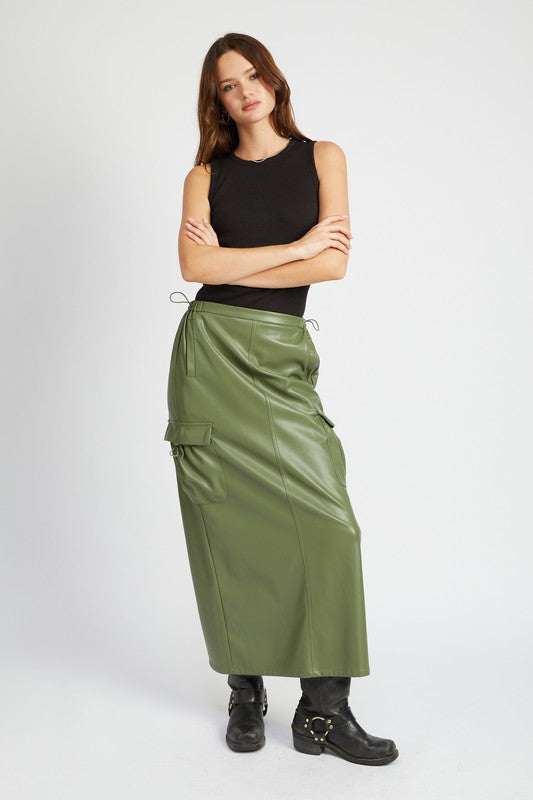 AVAH-Model in black top and olive vegan leather skirt with arms crossed, full outfit