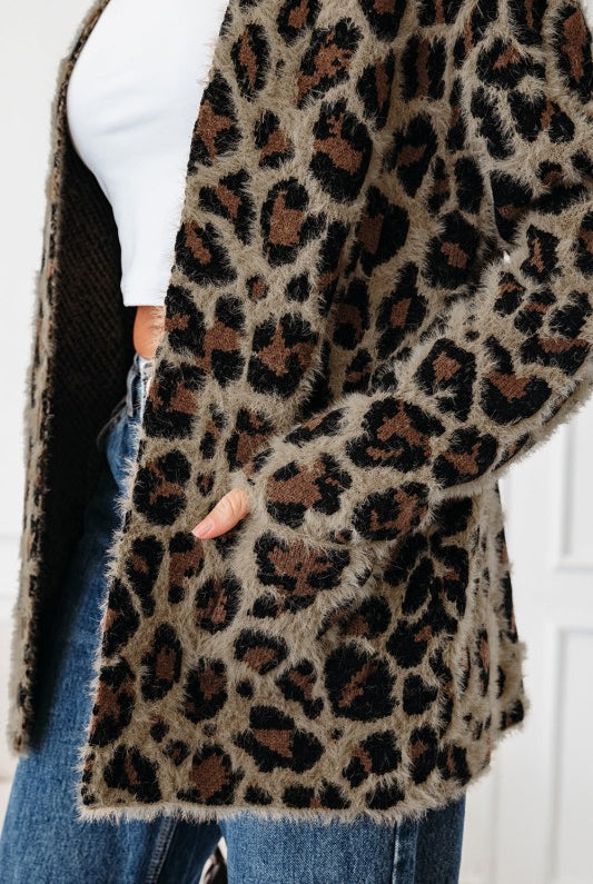 Close-up of cardigan pocket and textured knit fabric.