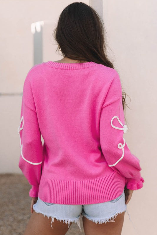 back view of pink bow accent sweater showing relaxed fit