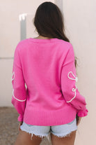 back view of pink bow accent sweater showing relaxed fit