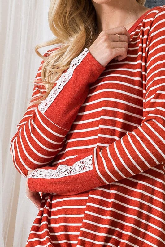 The Stripe Light Sweater is a cozy fall staple for every girl’s closet. With a relaxed fit and flattering twist front, this top can be styled with comfortable jeans or your favorite leggings. The lace trim sleeves add a romantic touch to the design, making it perfect for date night or an afternoon coffee date with friends.