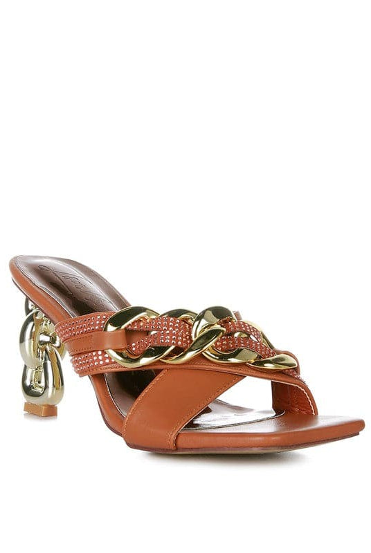 Give your look a unique touch of creativity with these stylish metallic chain-heeled sandals. The golden chain strap and head-turning diamante detail will give any outfit the right amount of edge and glamour. Chic, unique, and full of style. Avah Couture