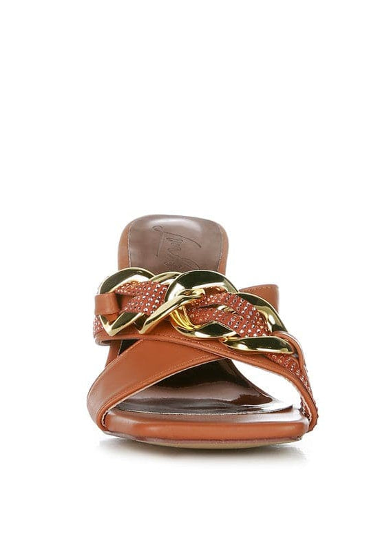 Give your look a unique touch of creativity with these stylish metallic chain-heeled sandals. The golden chain strap and head-turning diamante detail will give any outfit the right amount of edge and glamour. Chic, unique, and full of style. Avah Couture