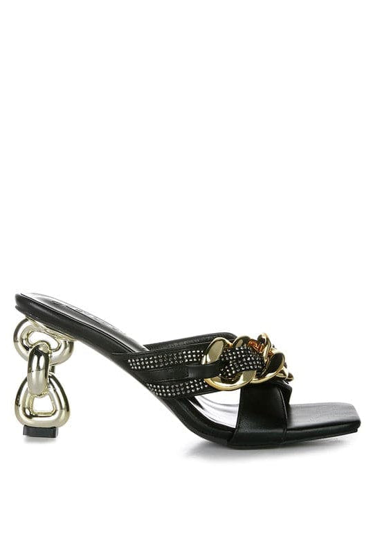 Give your look a unique touch of creativity with these stylish metallic chain-heeled sandals. The golden chain strap and head-turning diamante detail will give any outfit the right amount of edge and glamour. Chic, unique, and full of style. Avah Couture