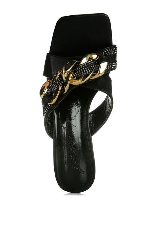 Give your look a unique touch of creativity with these stylish metallic chain-heeled sandals. The golden chain strap and head-turning diamante detail will give any outfit the right amount of edge and glamour. Chic, unique, and full of style. Avah Couture